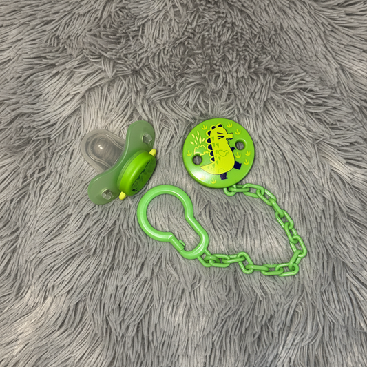 Dino Pacifier Flat on Grey Fur